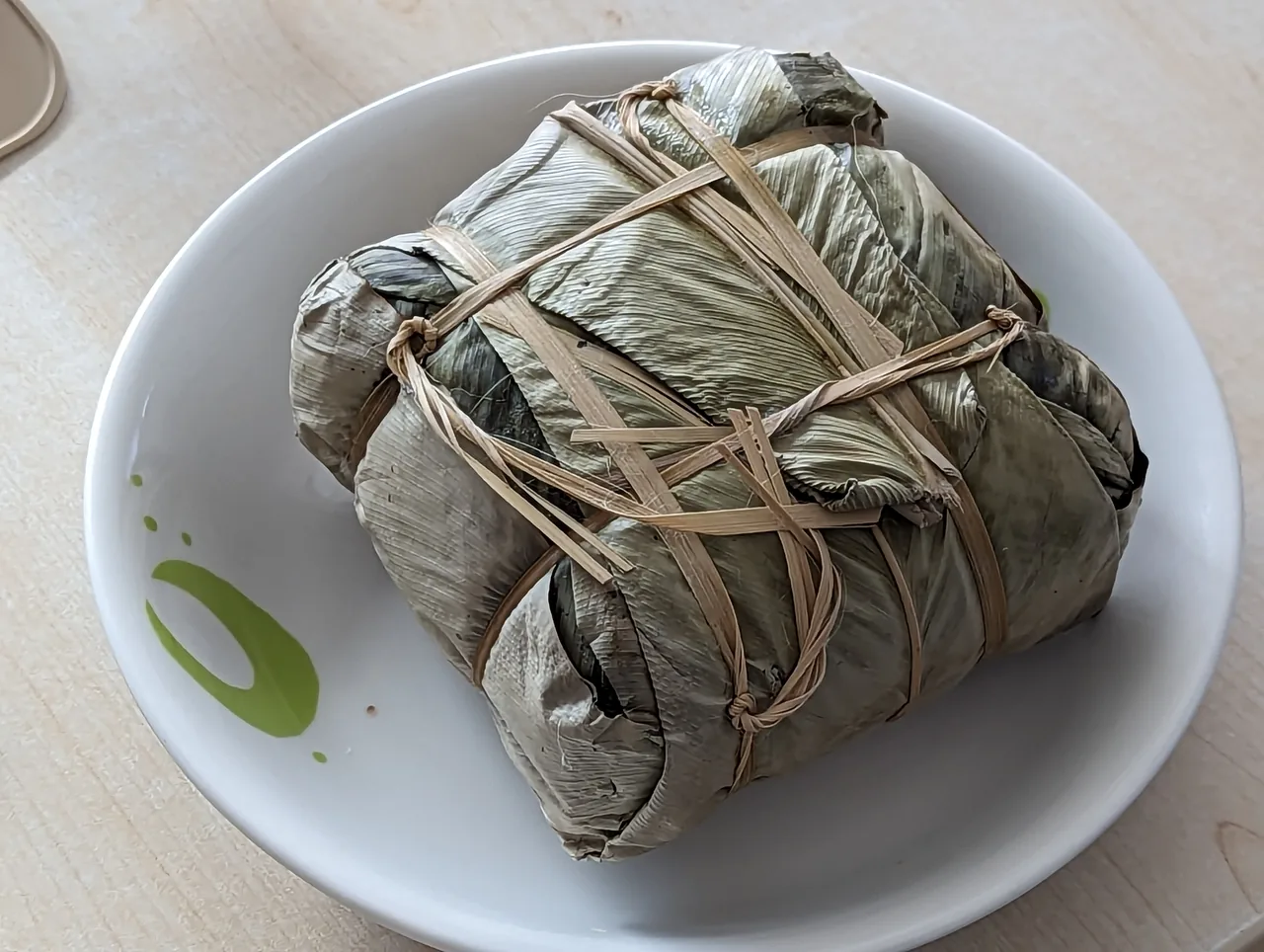 Banh chung, the square sticky-rice cakes wrapped in green leaves eaten at Tết