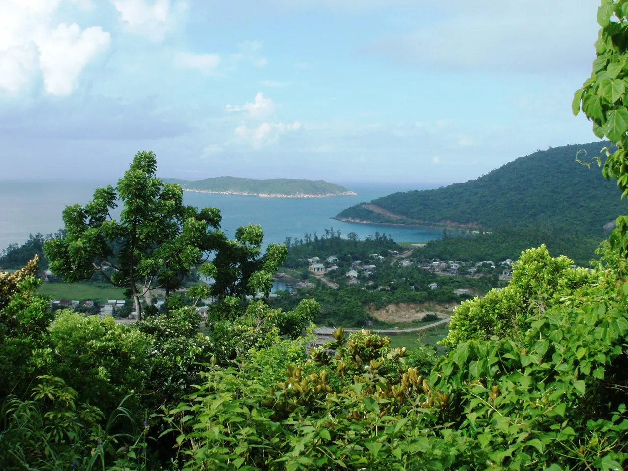Elevated view over a Cu Lao Cham bay, the island village and green hills
