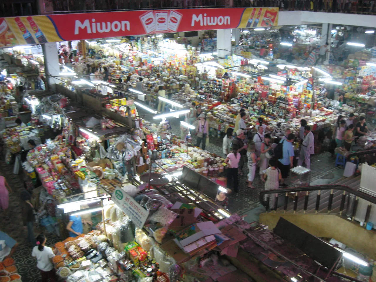 Lantern-lit covered market stalls in Da Nang on a wet day