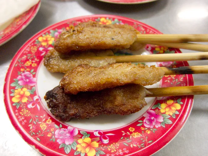 Nem lụi — grilled lemongrass pork skewers on bamboo sticks
