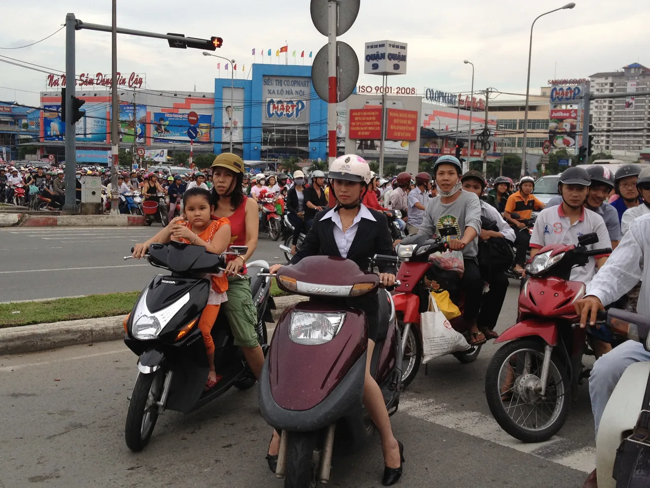 A rider in a helmet on a scooter in Vietnamese traffic