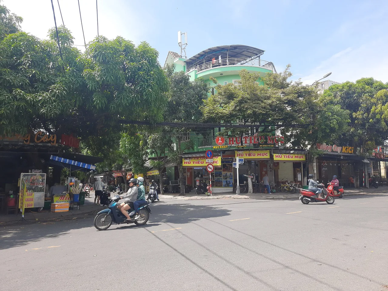 A local street intersection in Da Nang with motorbikes and shops