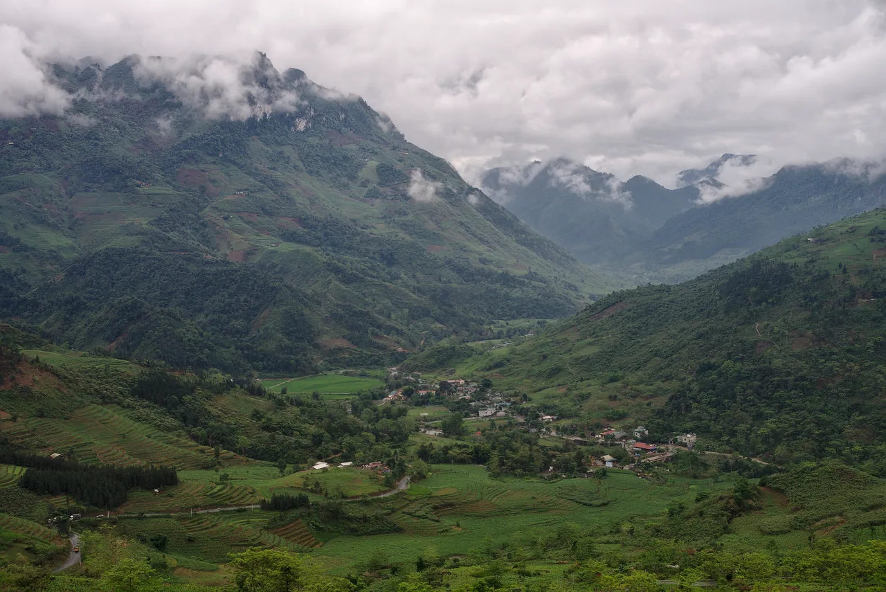 A winding mountain road, the Happiness Road, snaking through grey limestone karst peaks in Ha Giang A winding mountain road, the Happiness Road, snaking through grey limestone karst peaks in Ha Giang