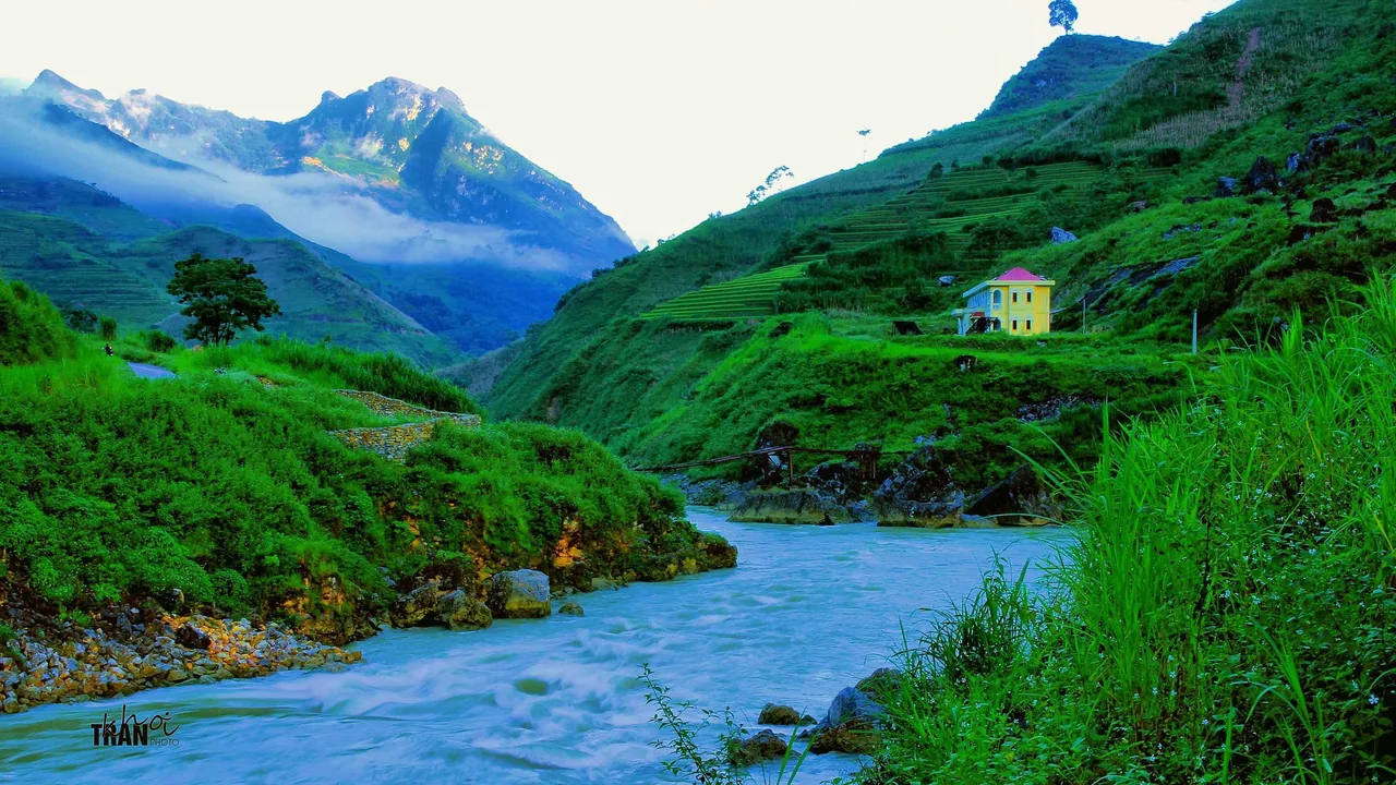 The emerald Nho Que River in the narrow Tu San canyon with a small boat on the water The emerald Nho Que River in the narrow Tu San canyon with a small boat on the water