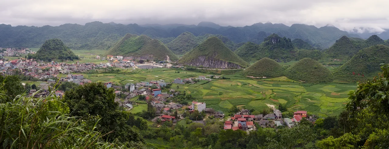 The Quan Ba Twin Mountains and a terraced green valley seen from a high viewpoint The Quan Ba Twin Mountains and a terraced green valley seen from a high viewpoint