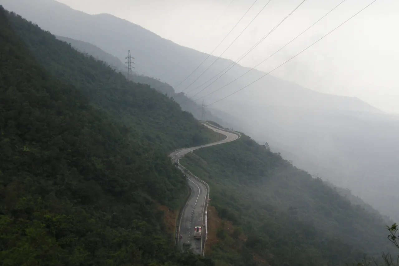 The winding Hai Van Pass road through misty mountains, Vietnam