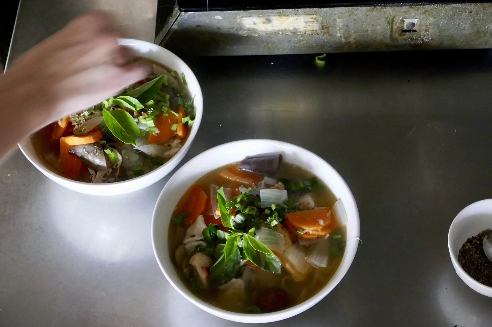 Bowls of fresh Vietnamese dishes with herbs at a Hoi An cooking class