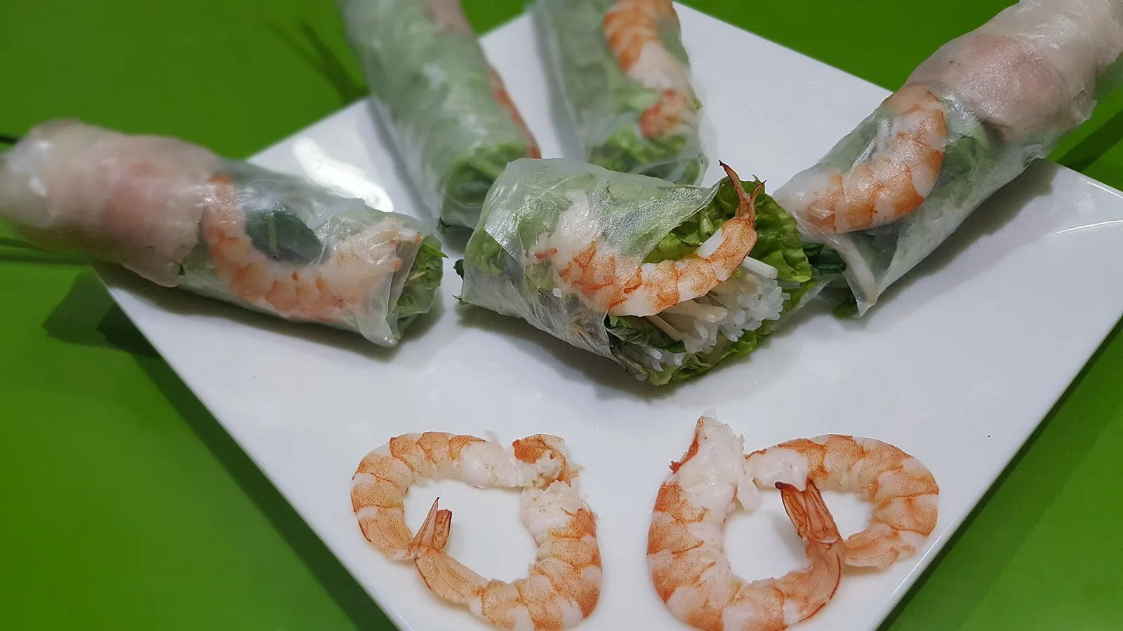 Fresh Vietnamese spring rolls being rolled by hand