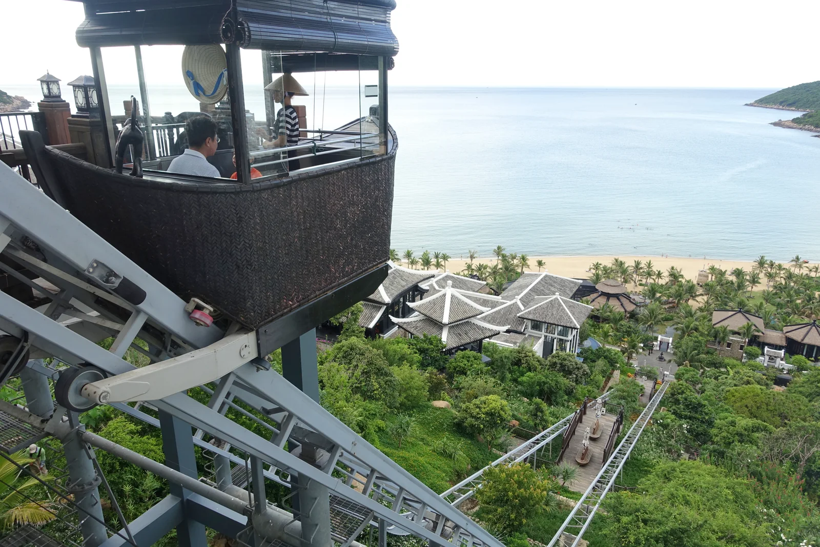 Whitewashed colonial-style resort pavilions of InterContinental Danang Sun Peninsula stepping down the jungled Son Tra hillside above the sea