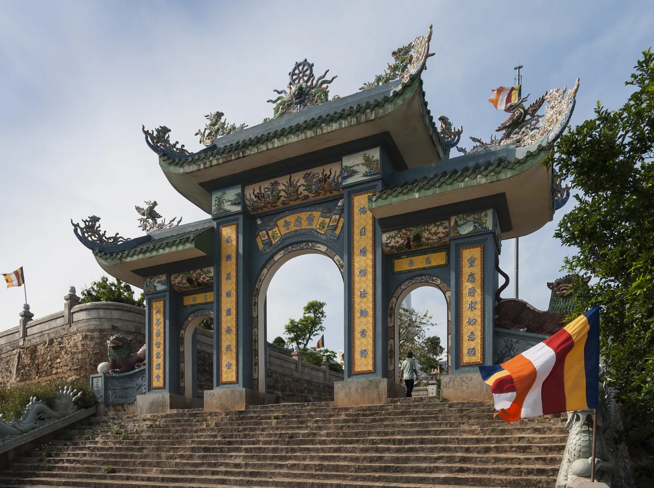 The ornate, dragon-decorated entrance gate of Linh Ung Pagoda on Son Tra, with Buddhist flags The ornate, dragon-decorated entrance gate of Linh Ung Pagoda on Son Tra, with Buddhist flags