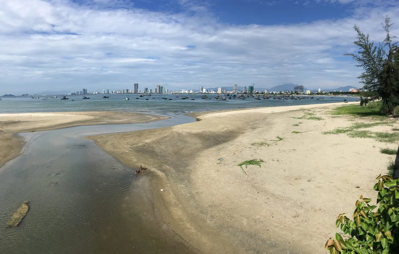 My Khe Beach in Da Nang with boats by the shore under clear skies