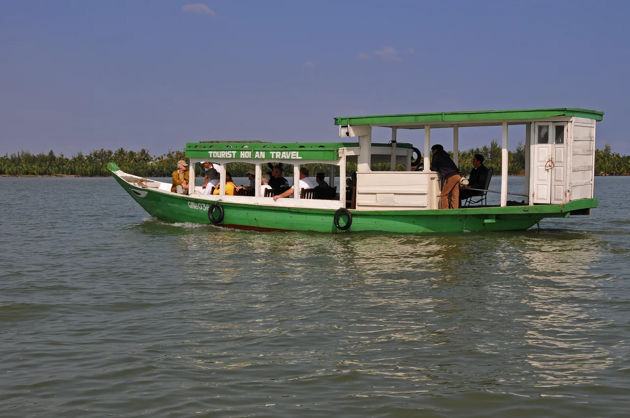 A wooden boat on the Thu Bon River beside Hoi An old town near Da Nang