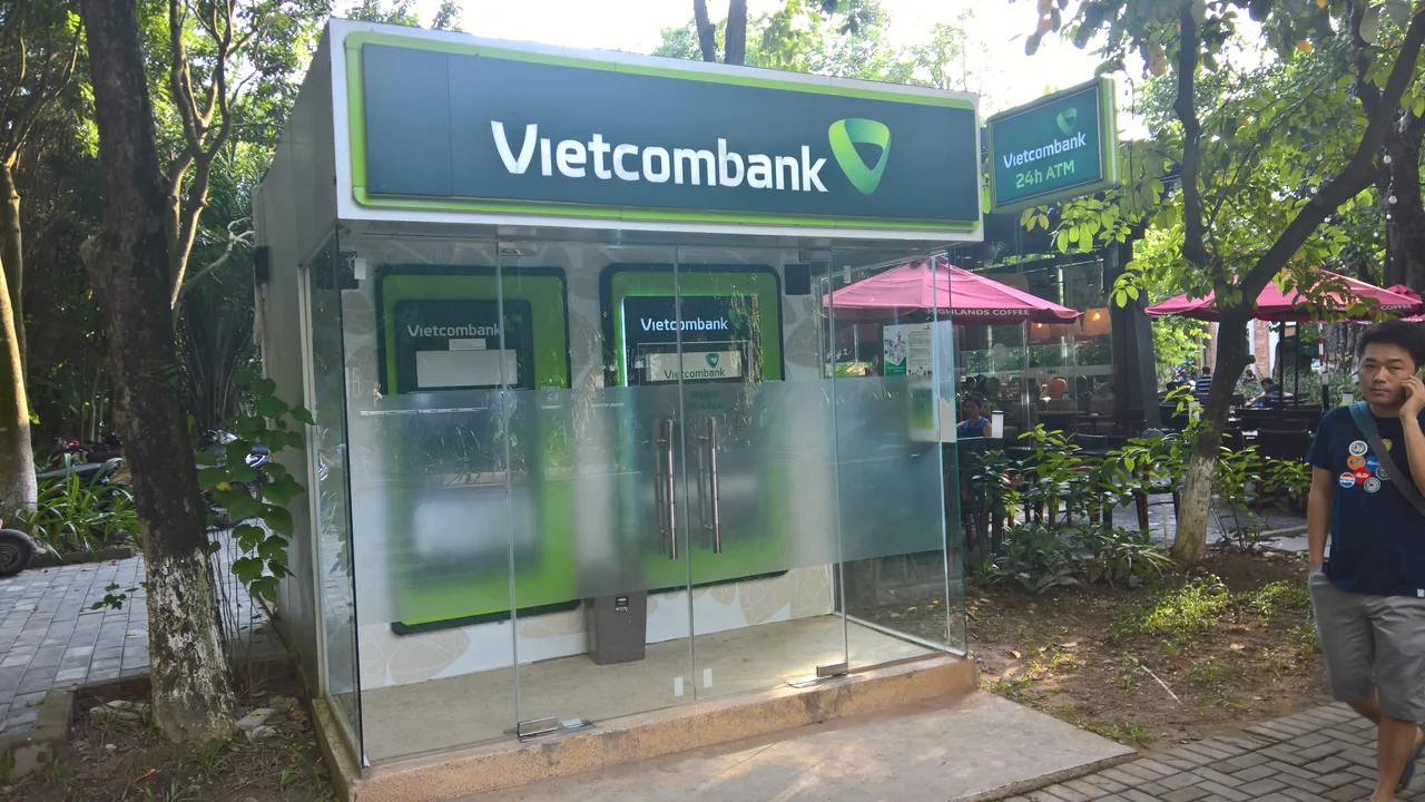 A traveller withdrawing cash from an ATM in Vietnam A traveller withdrawing cash from an ATM in Vietnam