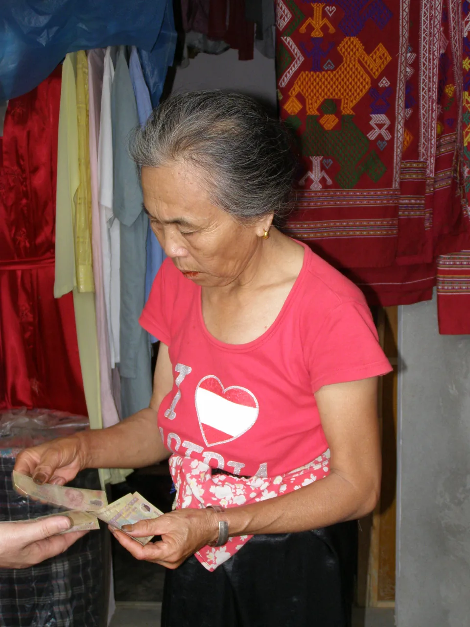 Paying with cash at a Da Nang street food stall Paying with cash at a Da Nang street food stall