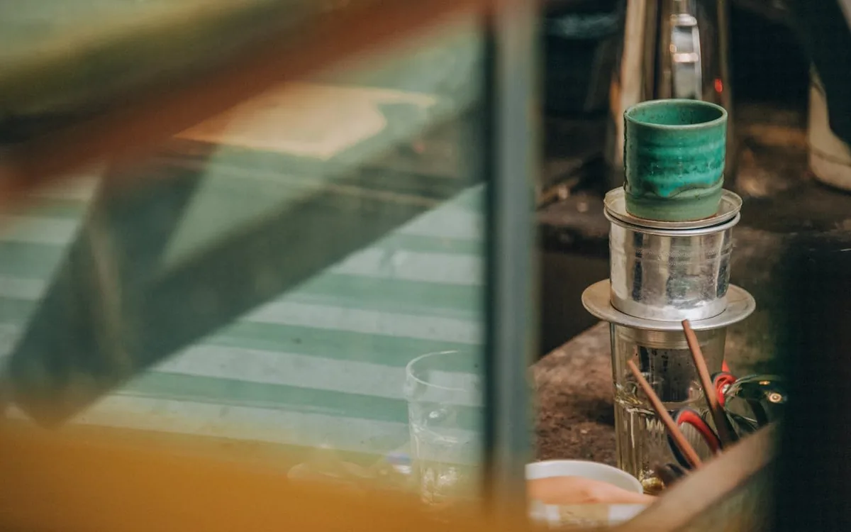 Vietnamese coffee dripping through a traditional phin filter