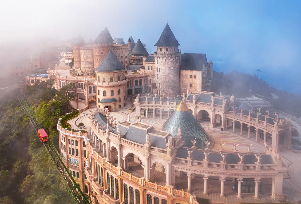 The castle towers of Ba Na Hills emerging from thick fog