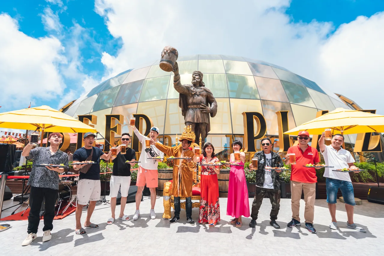 Visitors with beer mugs at Beer Plaza, Ba Na Hills