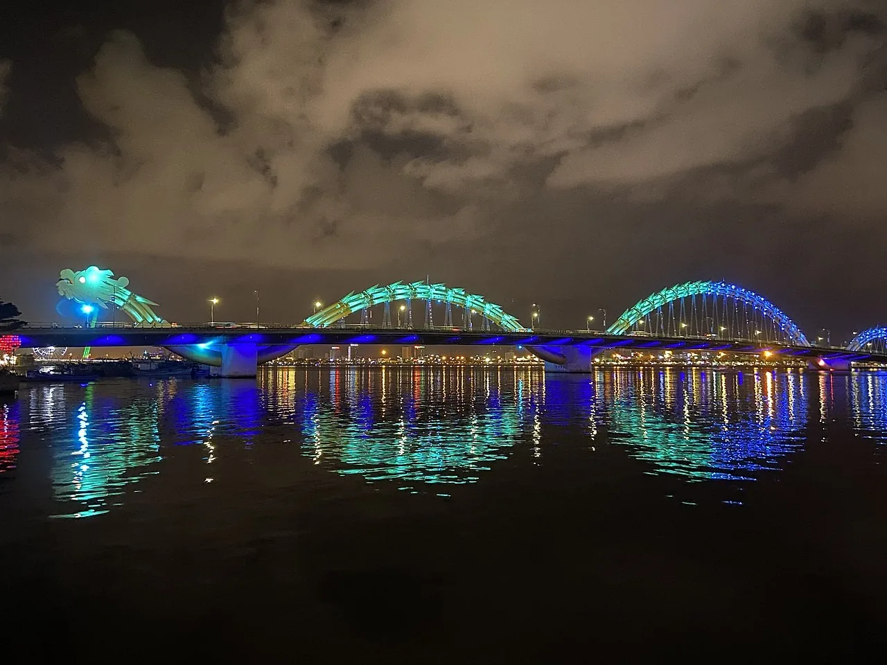 The Dragon Bridge lit up at night, its steel dragon spanning the Han River in Da Nang The Dragon Bridge lit up at night, its steel dragon spanning the Han River in Da Nang