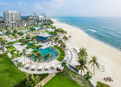 Aerial exterior view of Hyatt Regency Danang Resort and Spa's low-rise buildings set among tropical gardens by the beach