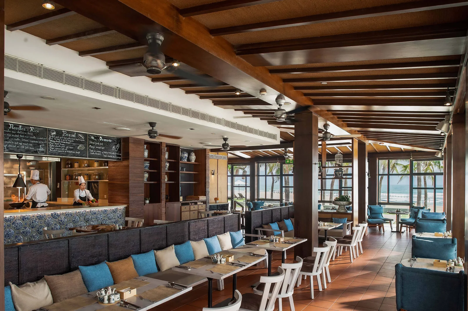 A poolside dining terrace at Hyatt Regency Danang Resort and Spa