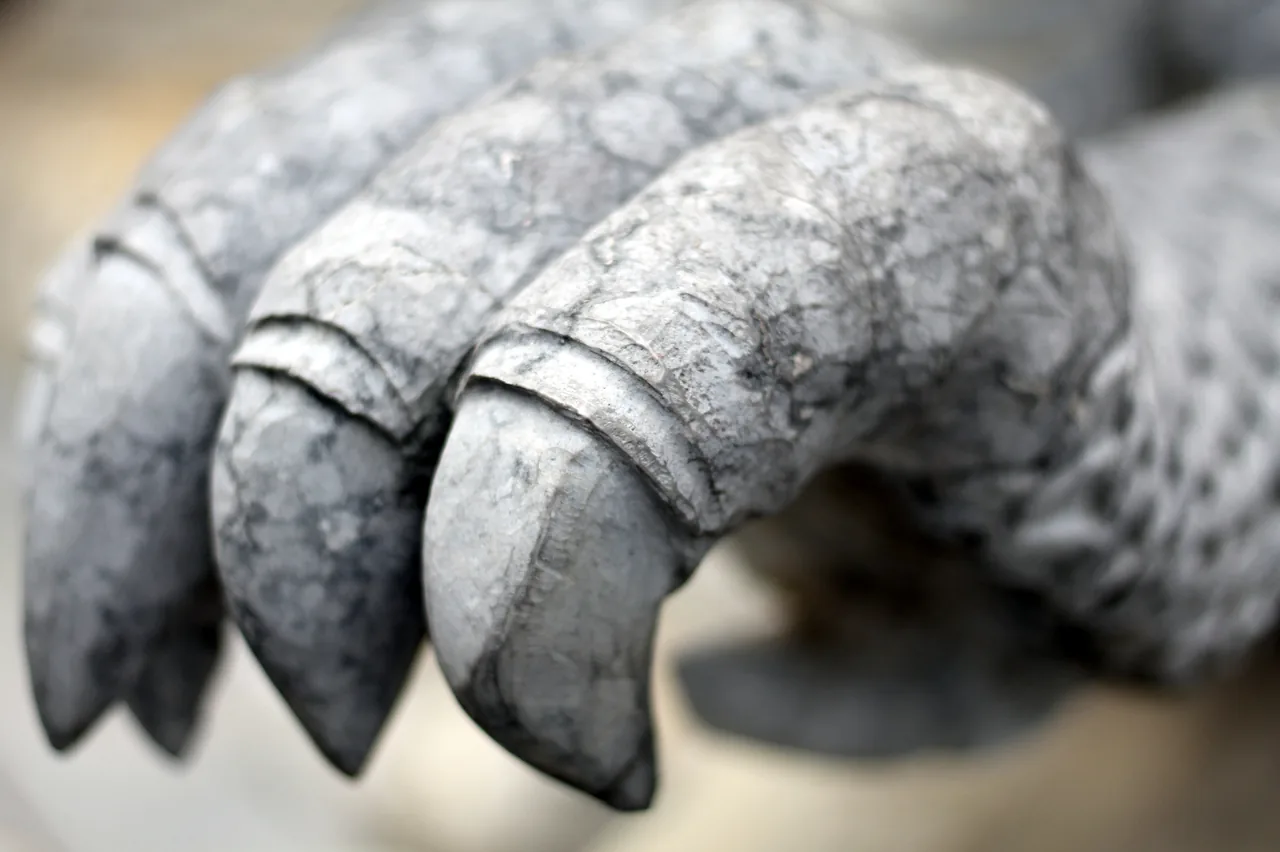A carved stone dragon claw guardian statue at the Marble Mountains, Non Nuoc craftsmanship