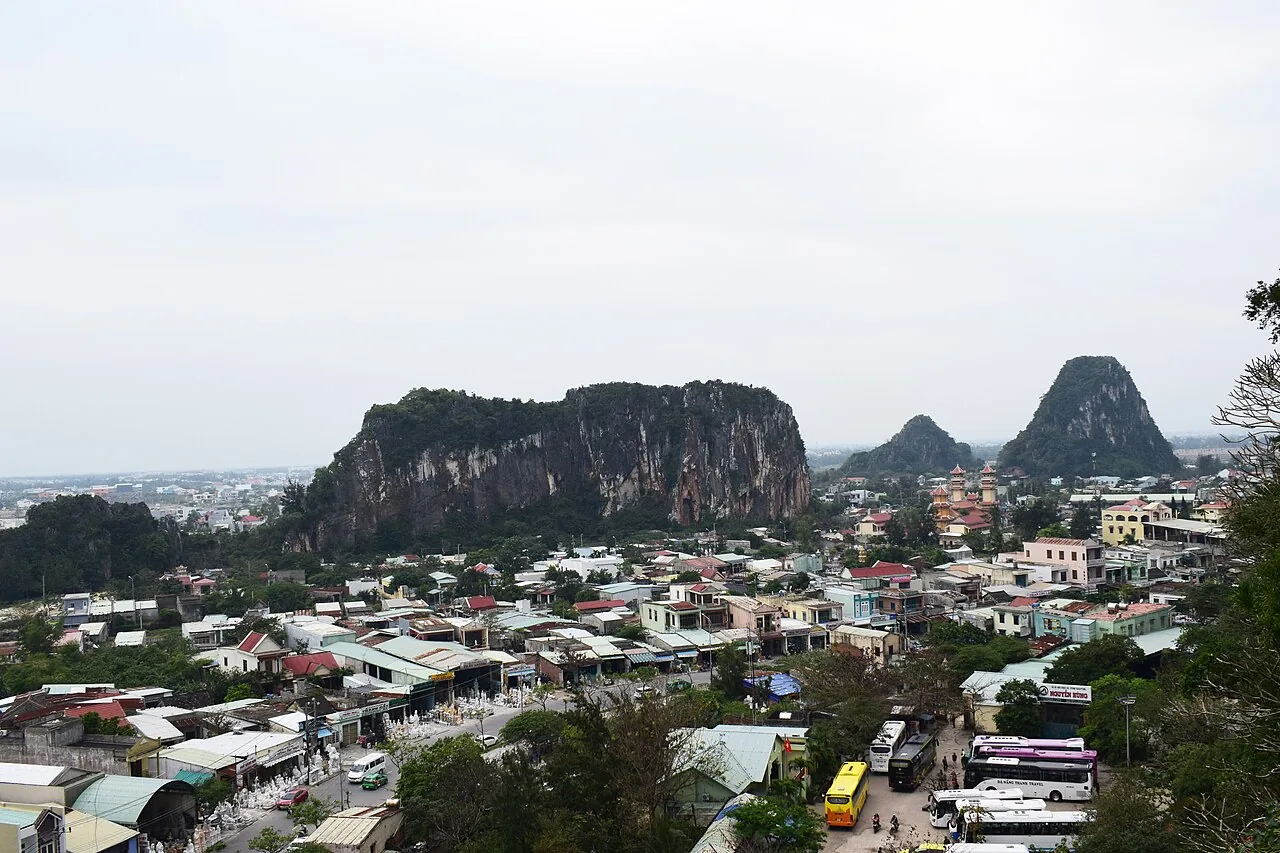 A wide panoramic view over Da Nang and the coastal plain from a rocky viewpoint near the summit of the Marble Mountains