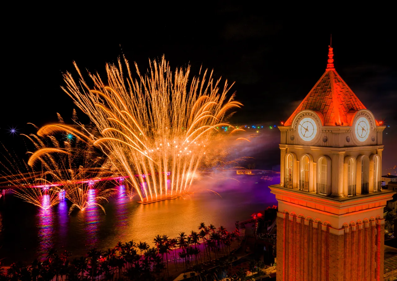 Fireworks explode over the clock tower at Sunset Town during the Symphony of the Sea show, Phu Quoc