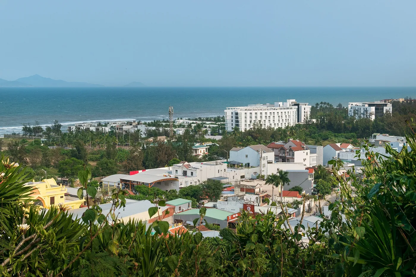 The coastline north of the Marble Mountains seen from the top, with the beach running towards Da Nang