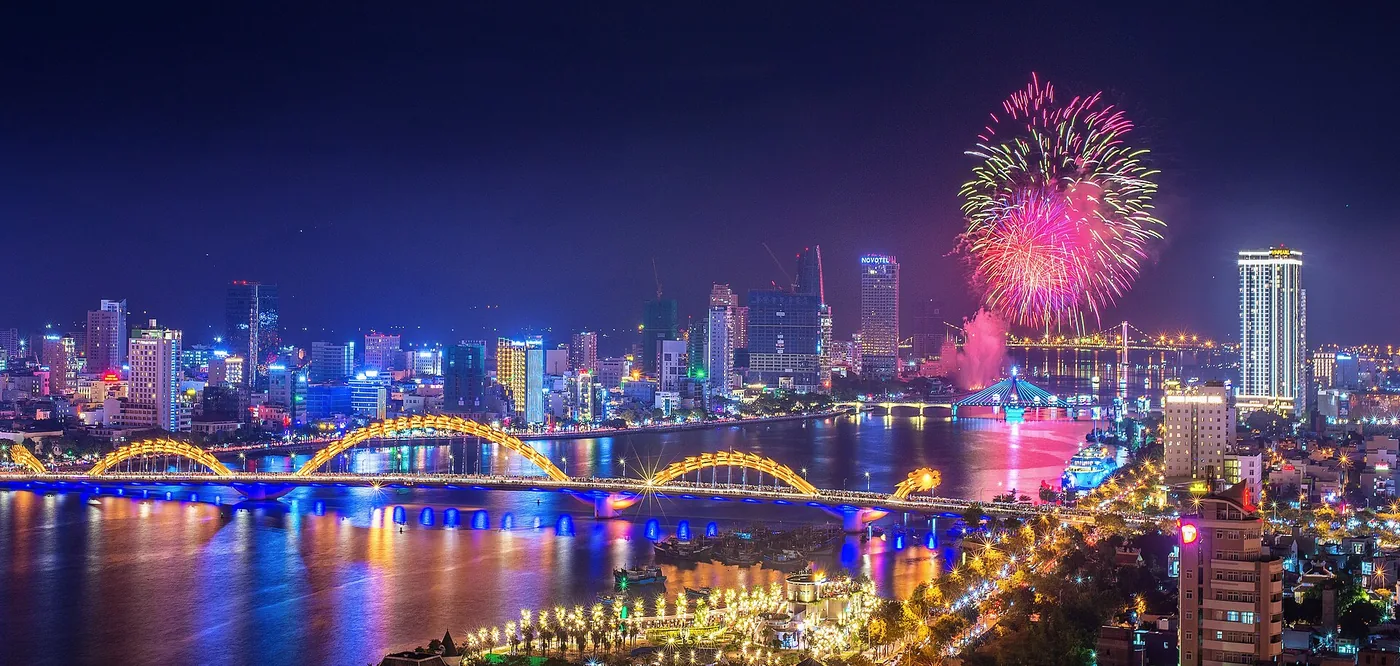 Fireworks over the Han River in Da Nang with the Dragon Bridge lit up below
