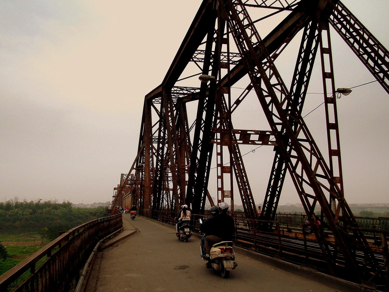 Century-old steel truss spans of Long Bien Bridge crossing the river in Hanoi