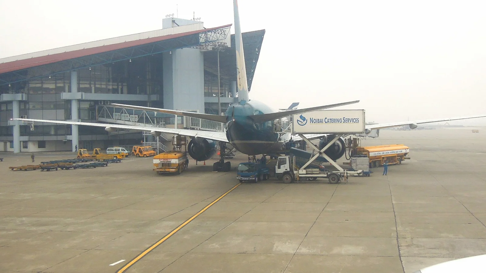 A passenger aircraft parked at a stand at Noi Bai International Airport in Hanoi