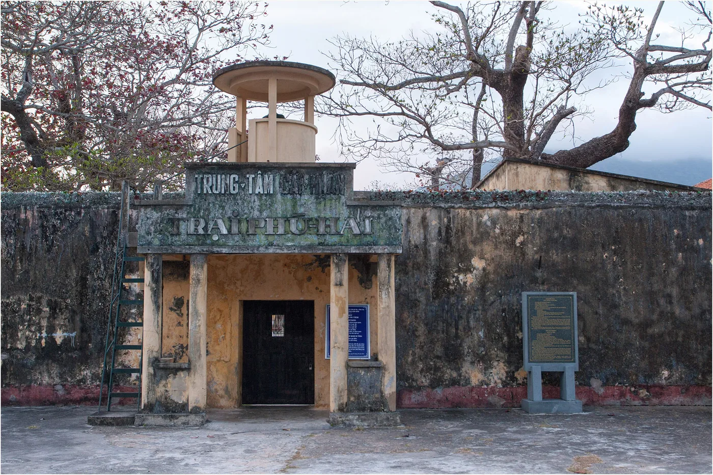 The gate of Phu Hai camp with a weathered watchtower above it