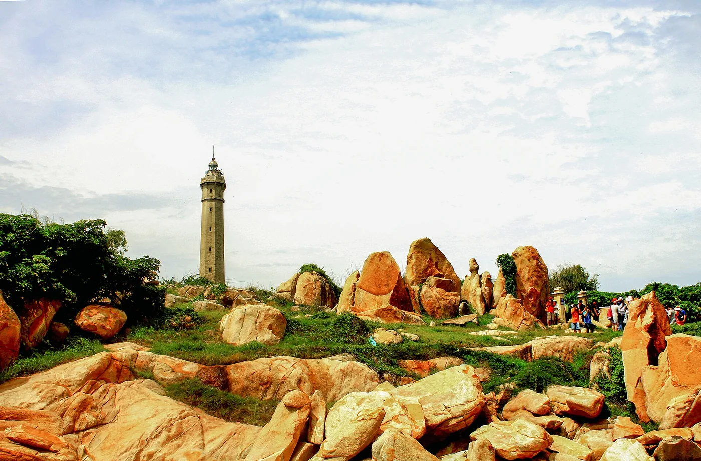 The Ke Ga lighthouse on its rocky island seen across the yellow boulders of the cape The Ke Ga lighthouse on its rocky island seen across the yellow boulders of the cape